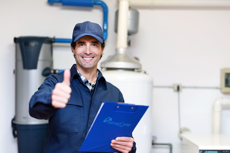 Smiling technician servicing a hot-water heater